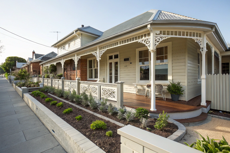 Traditional bullnose verandah with white posts and Colorbond roof on Central Coast home